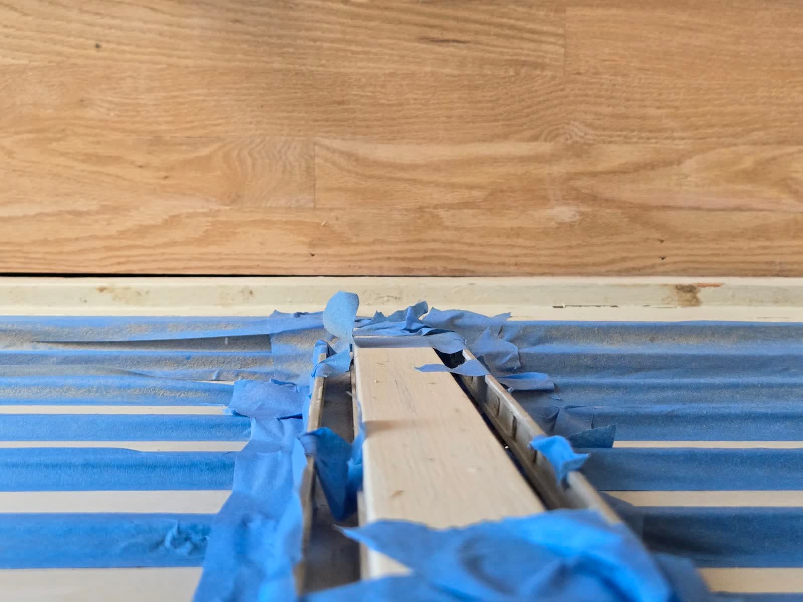 Sep 22: quarter round staged along the taped baseboard.